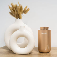 Lèlior de Paris Diffuser on table next to white round vases with white background | About Us | Lèlior