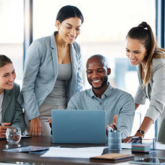 Careers - team looking at laptop and smiling | Lèlior House of Fragrance