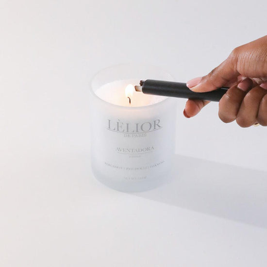 Luxury candle 10oz Aventadora scent white backround hand lighting the candle 