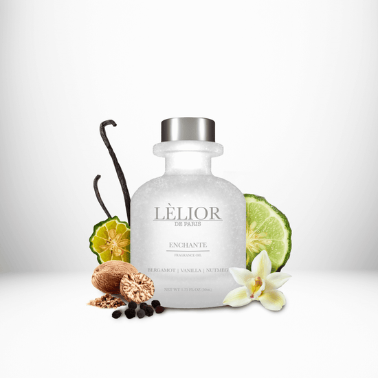 ENCHANTE Fragrance Oil displayed with surrounding fragrance notes, featuring a 50mL clear front glass bottle that highlights the rich, aromatic blend.