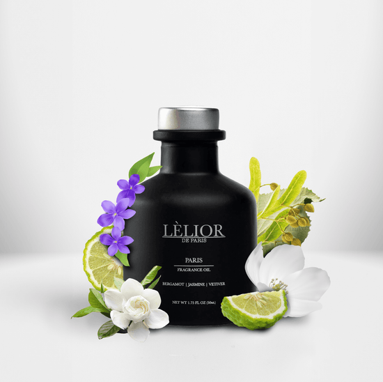 50ml black glass bottle with silver lettering and silver cap. Paris scent with notes of bergamot, jasmine, and vetiver around the bottle. White background