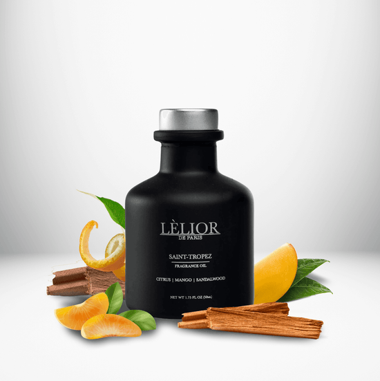 50ml black glass bottle with silver lettering and silver cap. Saint-Tropez scent with notes of citrus, mango, and sandalwood around the bottle. White background